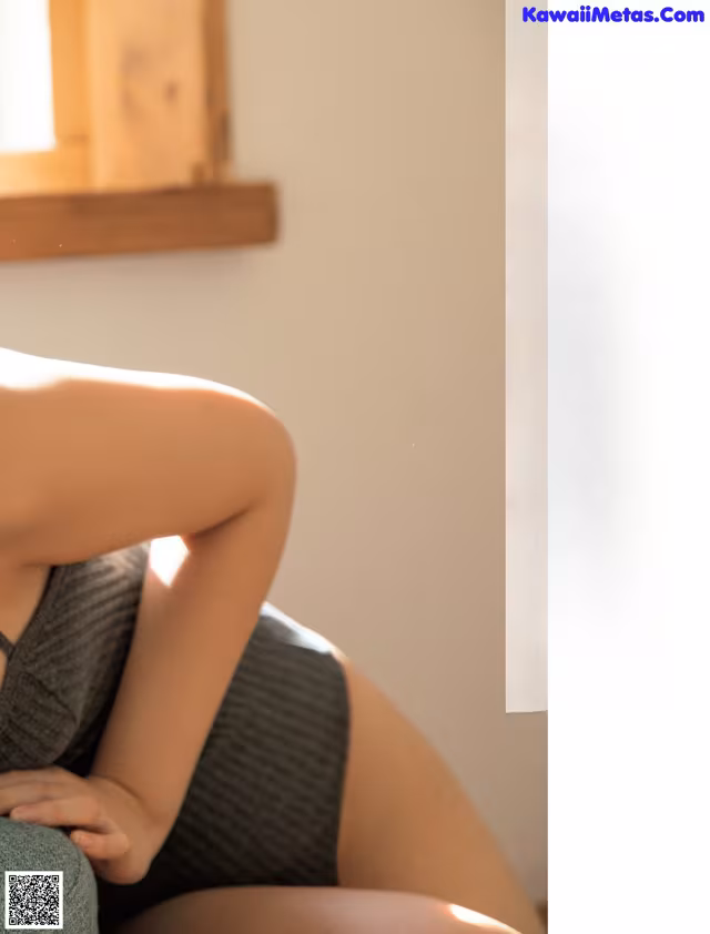 A woman sitting on a couch with her legs crossed.