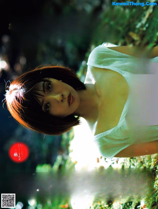 A poster for a Japanese movie with a woman in a white dress.