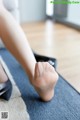 A woman's bare feet on a yoga mat.