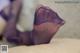 A close up of a woman's feet in purple stockings.