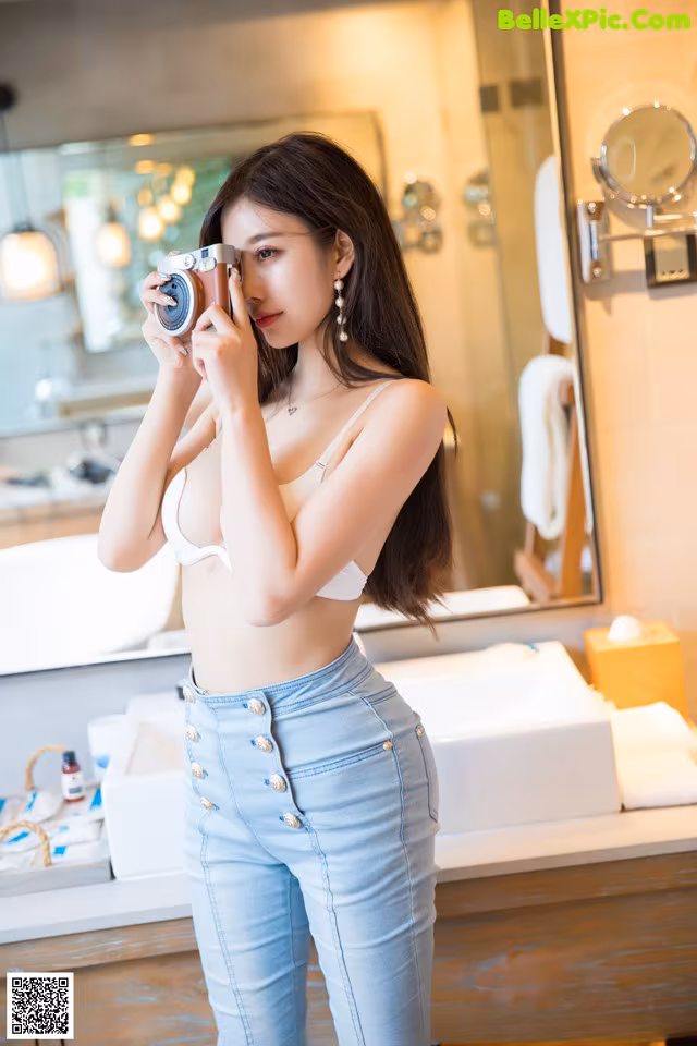 A woman taking a picture of herself in a mirror.