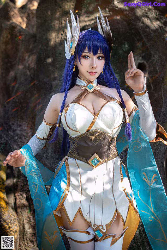 A woman in a white and blue outfit posing for a picture.