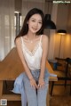 A woman sitting on top of a wooden table.